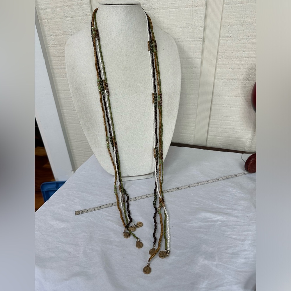 Long multi strand necklace with neutral tone beads and gold dangles